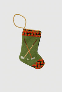 Needlepoint stocking with golf clubs, golf ball, and red plaid cuff on green background