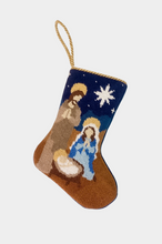 Hand-stitched stocking featuring the nativity scene with Joseph, Mary, and baby Jesus under a bright star on a navy blue and brown background