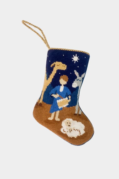 Hand-stitched stocking featuring the Little Drummer Boy playing his drum beside a camel, donkey, and sheep under a starry navy blue sky