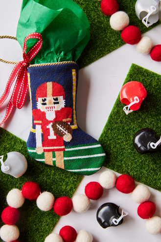 Football-themed Bauble Stockings styled with mini helmets and background like a football field
