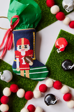 Football-themed Bauble Stockings styled with mini helmets and background like a football field