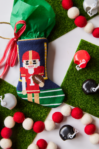 Football-themed Bauble Stockings styled with mini helmets and background like a football field