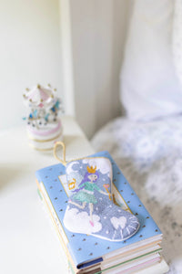 Tinsel Tooth Fairy Bauble Stockings arranged in playful holiday-themed flat lay with colorful accents
