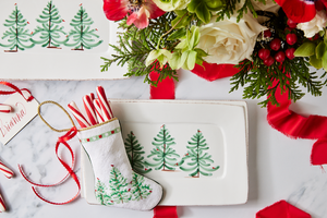 Christmas-themed table styled with Bauble Stockings, holiday greenery, and red and white festive accents