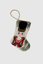 Bauble Stockings featuring a hand-stitched nutcracker in red uniform with gold details and festive green accents