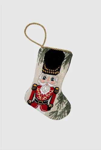 Bauble Stockings featuring a hand-stitched nutcracker in red uniform with gold details and festive green accents