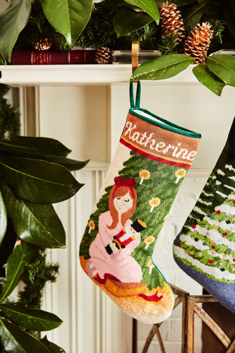 Full-size Christmas stocking with a monogrammed name in script featuring Clara in pink dress holding nutcracker with holiday greenery
