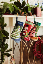 Festive mantle decorated with a Full Size Stockings, greenery, and holiday ornaments