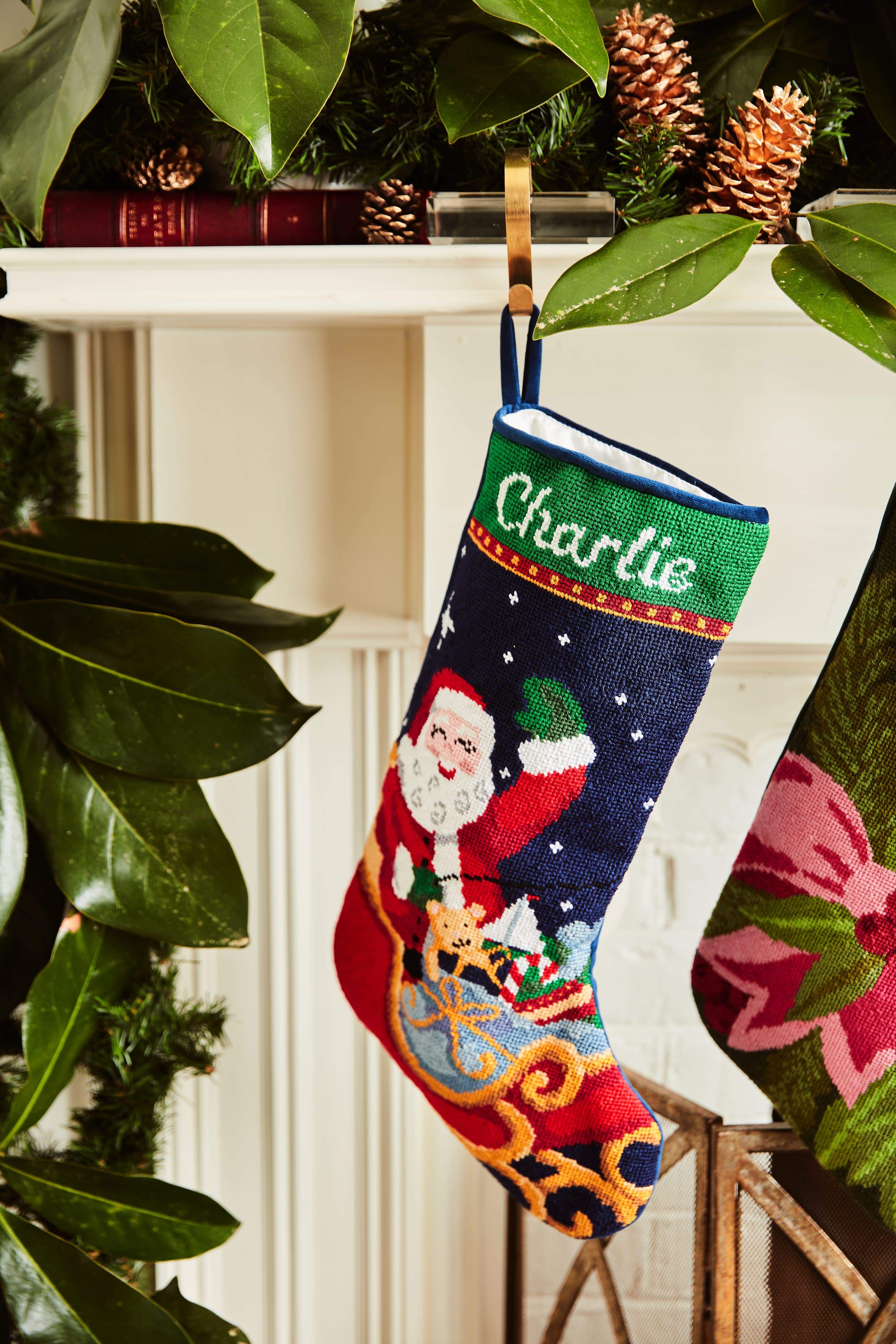 Full-size Christmas stocking with a monogrammed name in script featuring Santa flying in sleigh on a starry night sky