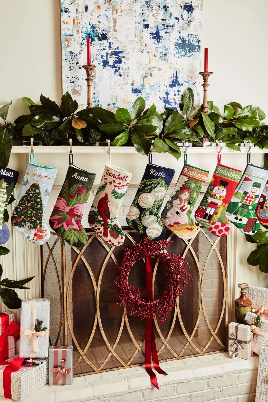 Festive mantle decorated with a Full Size Stockings, greenery, and holiday ornaments