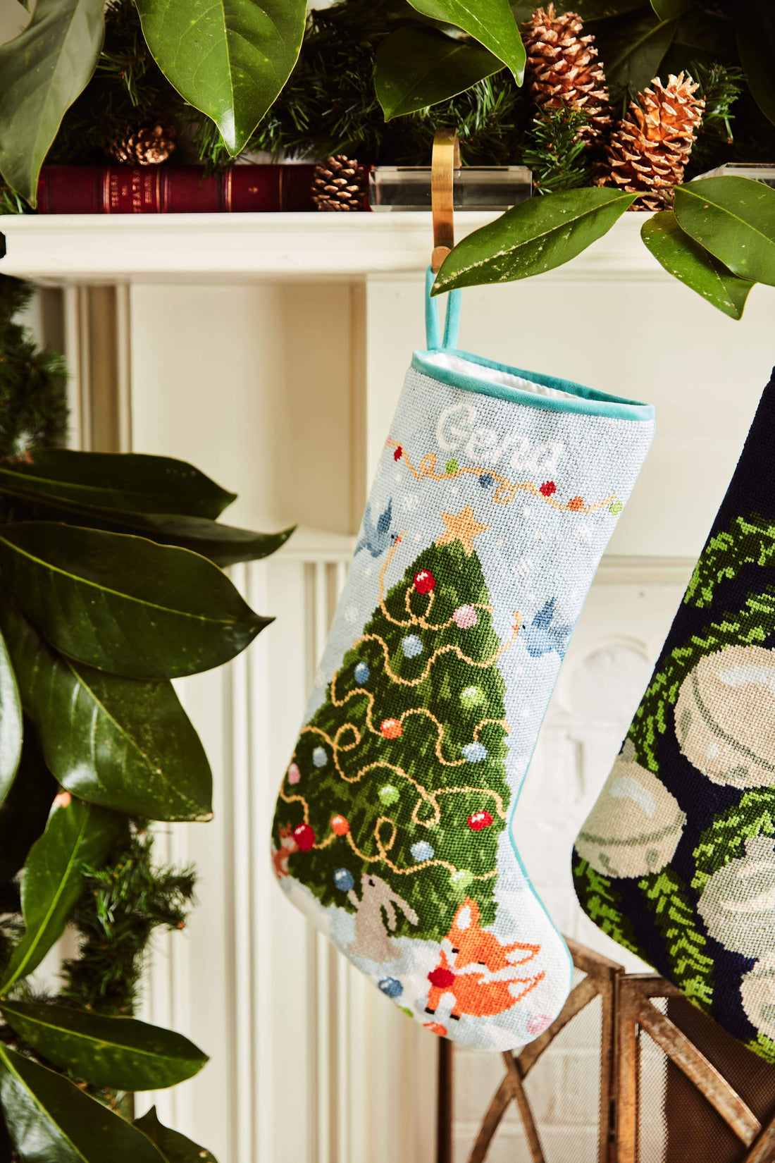 Full-size Christmas stocking with a monogrammed name in script featuring Woodland Creatures with decorated Christmas tree and animals in snowy setting