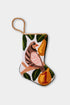 Needlepoint stocking featuring a partridge perched in a pear tree and green leaves on a white backdrop