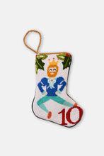 Hand-stitched stocking featuring a dancing man in a crown with greenery on a white background
