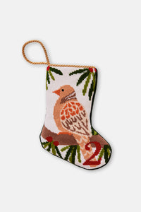 Needlepoint stocking featuring a turtle dove perched on greenery on a white setting