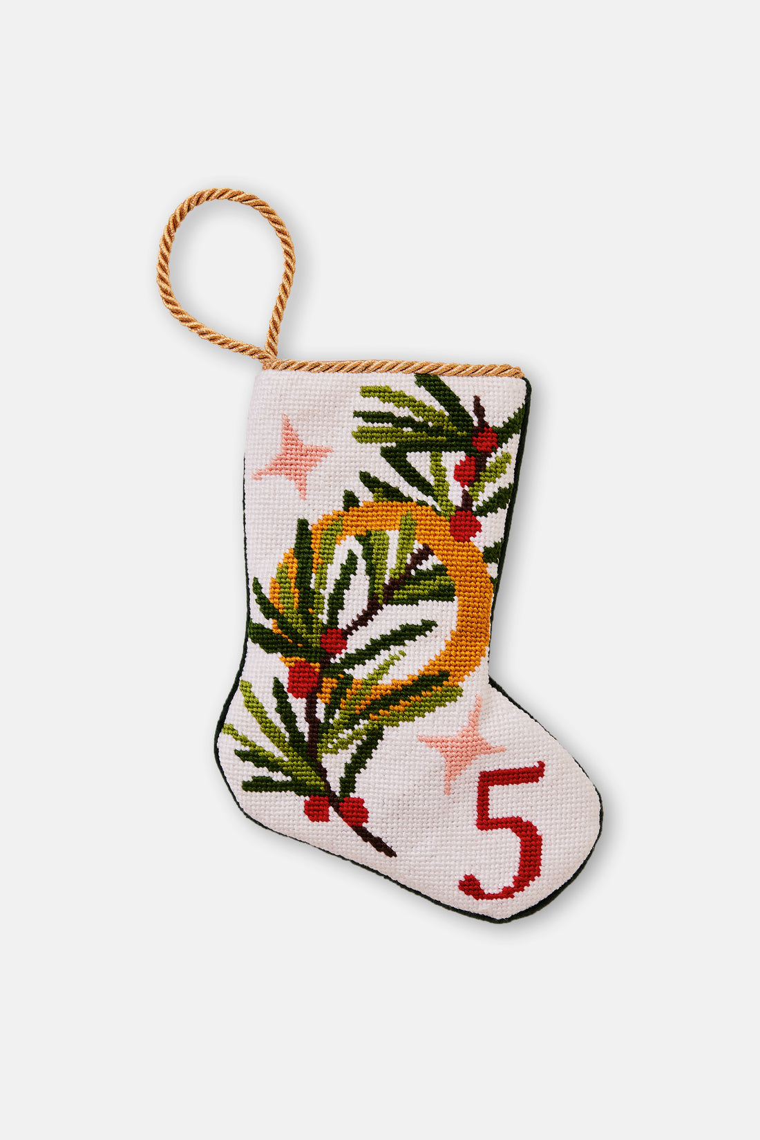 Needlepoint stocking featuring pine sprigs and a gold ring with festive stars on a white background