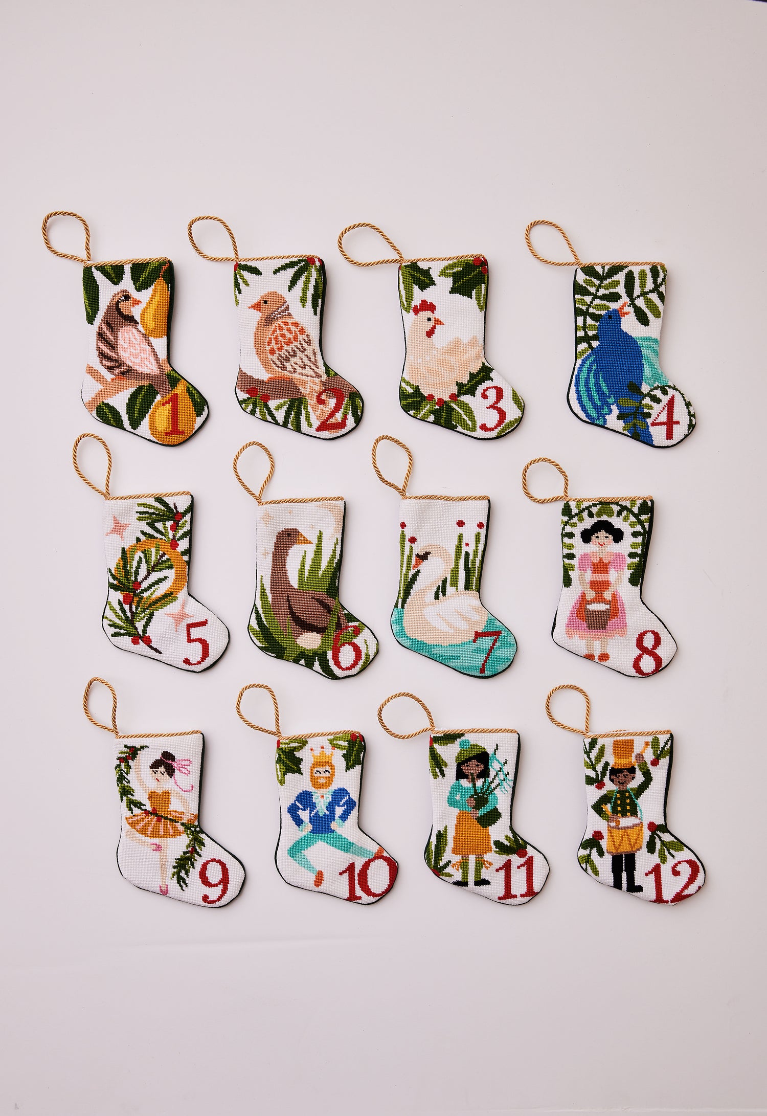 Full set of 12 hand-stitched needlepoint stockings featuring a unique design for each of the "12 Days of Christmas." Each stocking showcases vibrant colors with intricate designs
