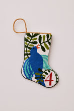 Hand-stitched needlepoint stocking featuring blue bird with lush green background