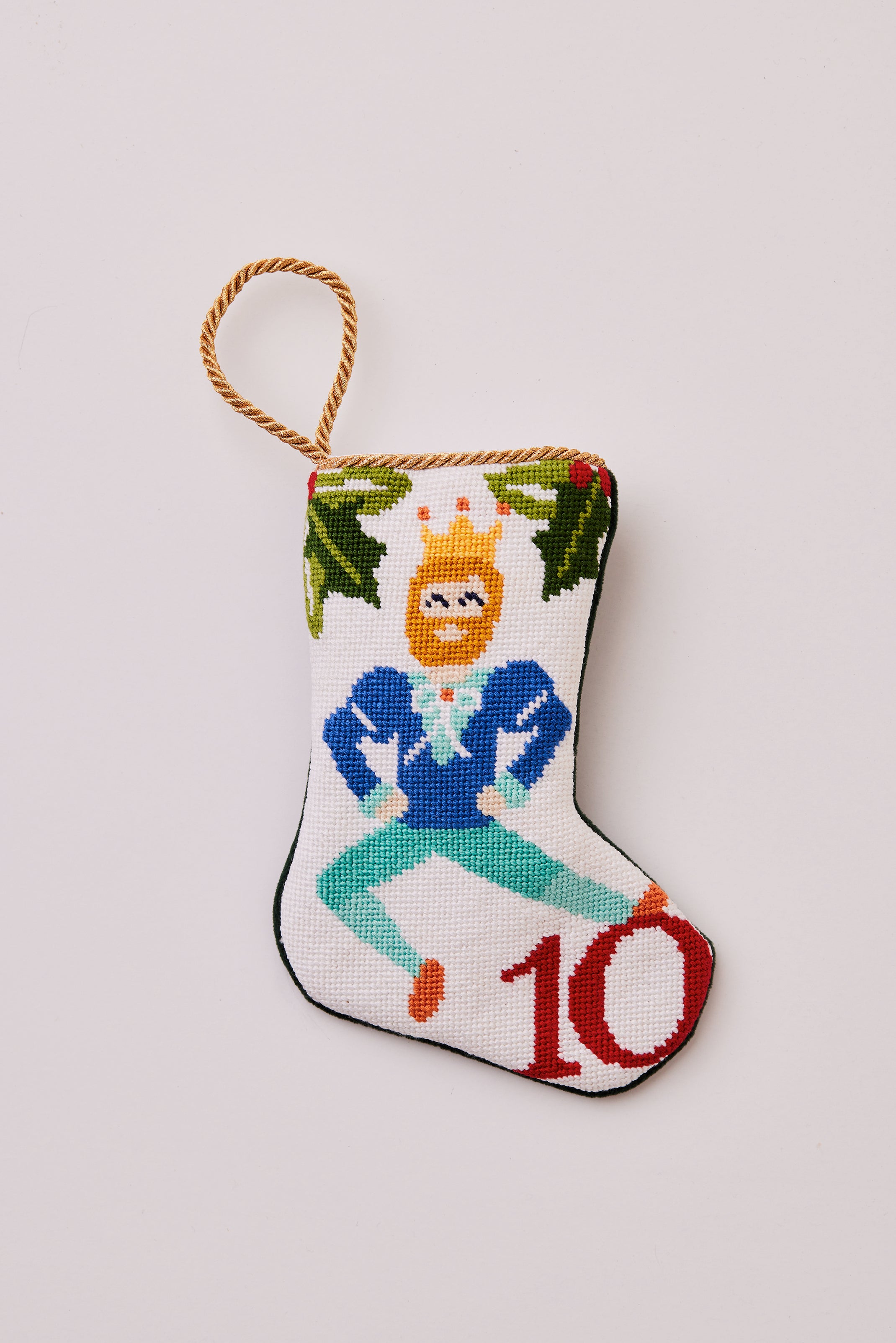 Hand-stitched stocking featuring a dancing man in a crown with greenery on a white background