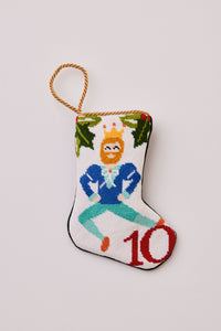 Hand-stitched stocking featuring a dancing man in a crown with greenery on a white background
