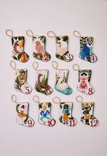 Full set of 12 hand-stitched needlepoint stockings featuring a unique design for each of the "12 Days of Christmas." Each stocking showcases vibrant colors with intricate designs