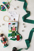 Bauble Stockings styled with green lace and ornaments for a sporty holiday setup