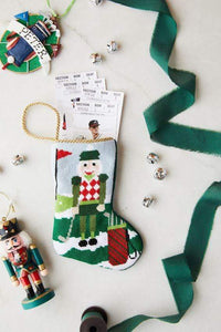 Bauble Stockings styled with green lace and ornaments for a sporty holiday setup