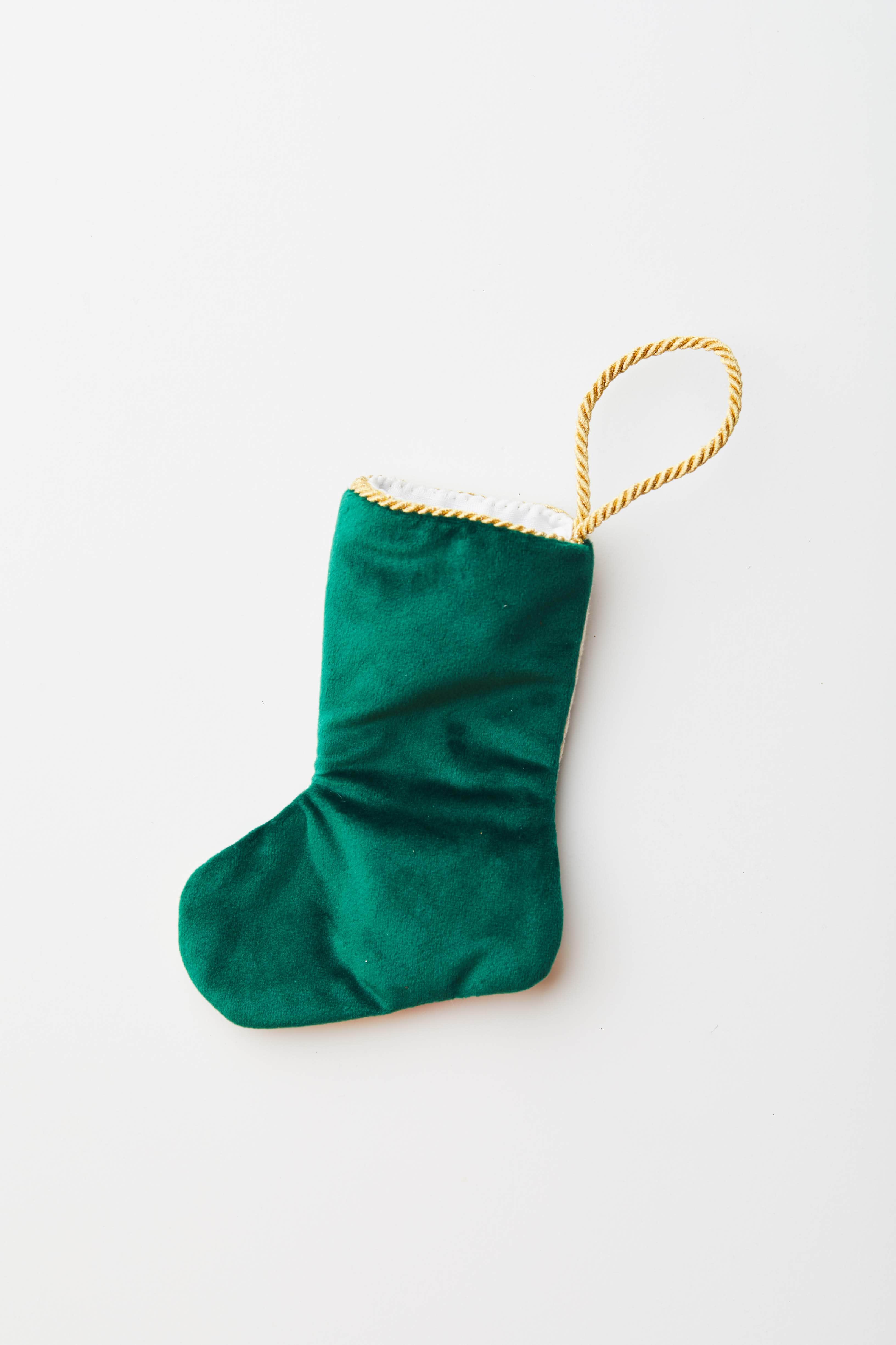 Back view of Clara with Nutcracker needlepoint stocking with solid green velvet backing