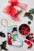Bauble Stockings styled with red bow, holly sprigs, and festive red and black ornaments