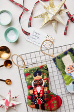 Gifting Nutcracker stocking styled with craft decor for a classic Christmas scene