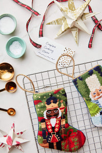 Gifting Nutcracker stocking styled with craft decor for a classic Christmas scene