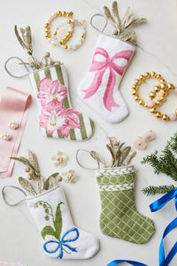 Holiday-themed Bauble Stockings displayed with pearl jewelry and festive ornaments