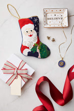 Bauble Stockings styled with red lace and holiday gift on a holiday setup