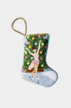 Hand-stitched stocking with ice skater in pink dress, icy rink, and ornamented evergreen tree