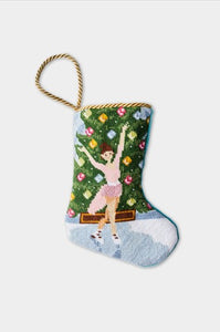 Hand-stitched stocking with ice skater in pink dress, icy rink, and ornamented evergreen tree
