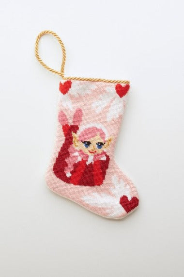 Hand-stitched Bauble Stockings featuring an elf with hearts and a red outfit on a pink background