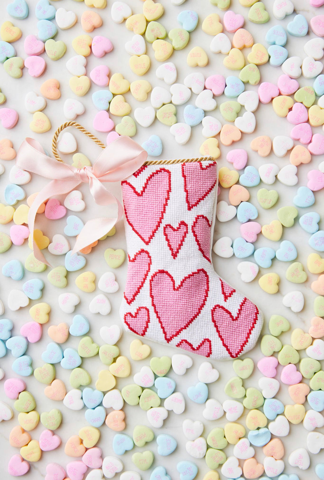 Bauble Stockings displayed with pastel-colored candy hearts and a festive, heart-filled holiday vibe