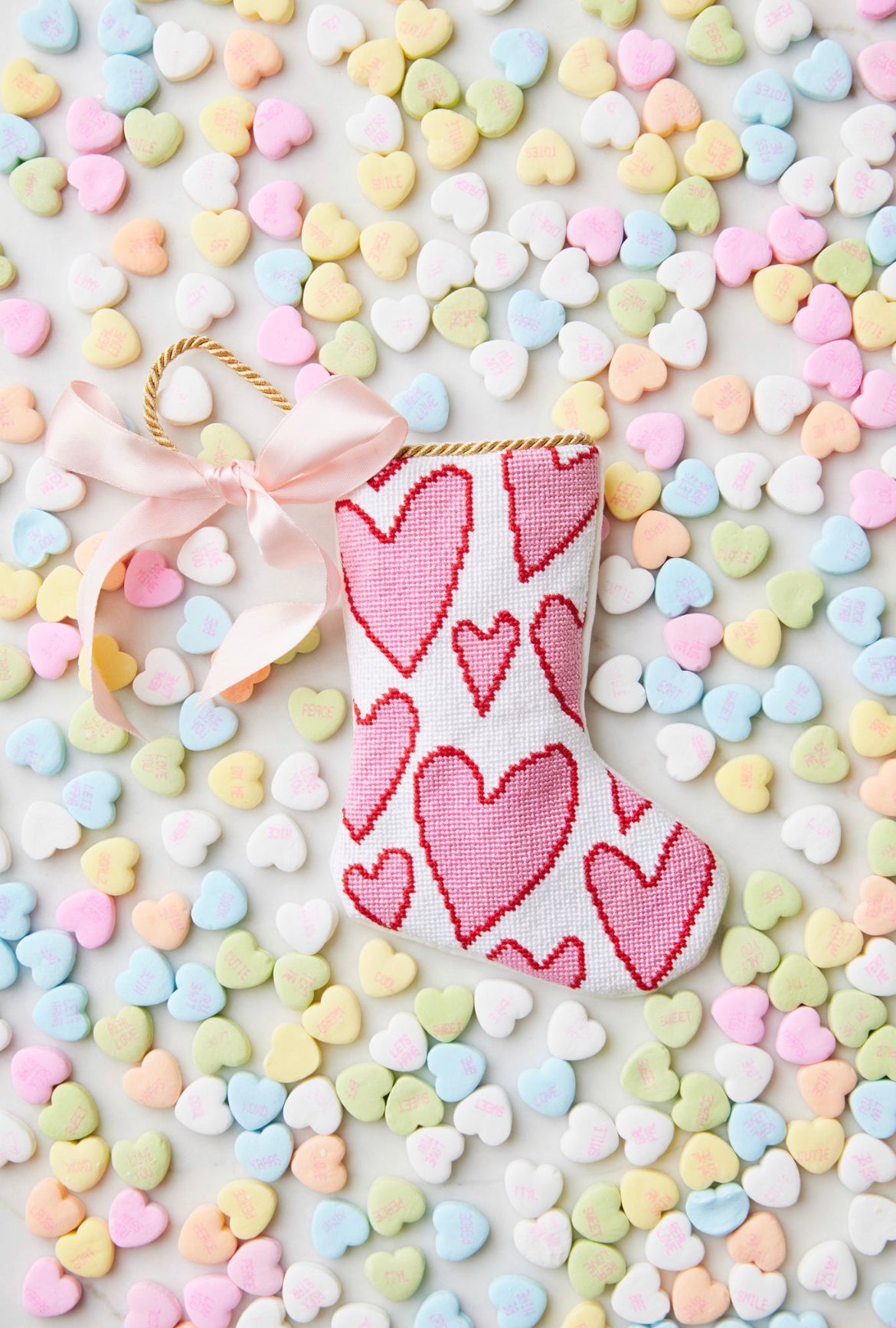 Bauble Stockings displayed with pastel-colored candy hearts and a festive, heart-filled holiday vibe