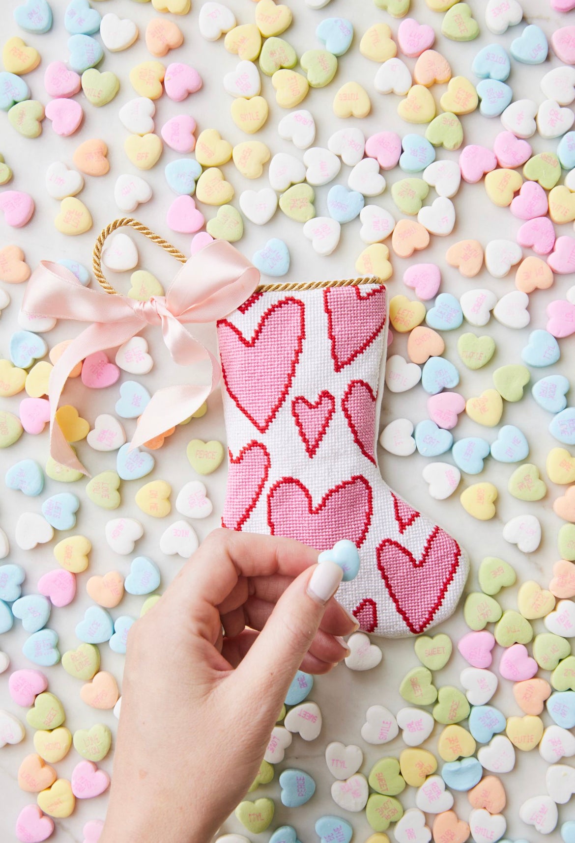 Bauble Stockings displayed with pastel-colored candy hearts and a festive, heart-filled holiday vibe