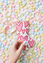 Bauble Stockings displayed with pastel-colored candy hearts and a festive, heart-filled holiday vibe