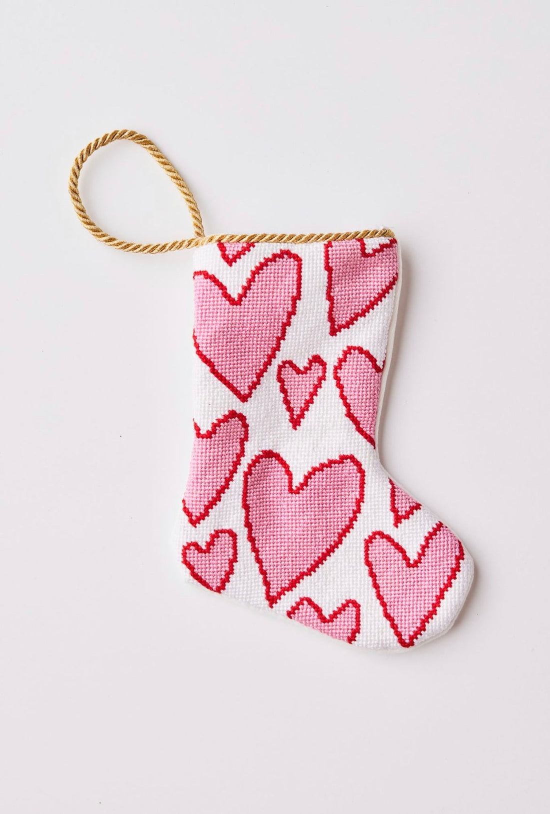 Needlepoint Bauble Stockings featuring pink hearts against a white background