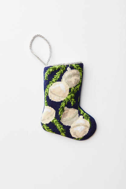 Needlepoint stocking with silver bells and green garland on navy blue background