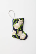 Needlepoint stocking with silver bells and green garland on navy blue background