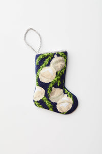 Needlepoint stocking with silver bells and green garland on navy blue background