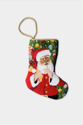 Hand-stitched Christmas stocking with Santa holding gifts in red suit and green ornamented background