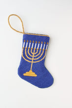 Hand-stitched Bauble Stockings featuring nine candles on a blue background
