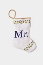 Hand-stitched stocking featuring the Mr. in blue lettering with green leafy accents on a white background