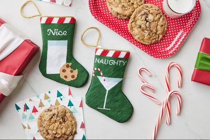 Hand-stitched Nice and Naughty Bauble Stockings on festive holiday background