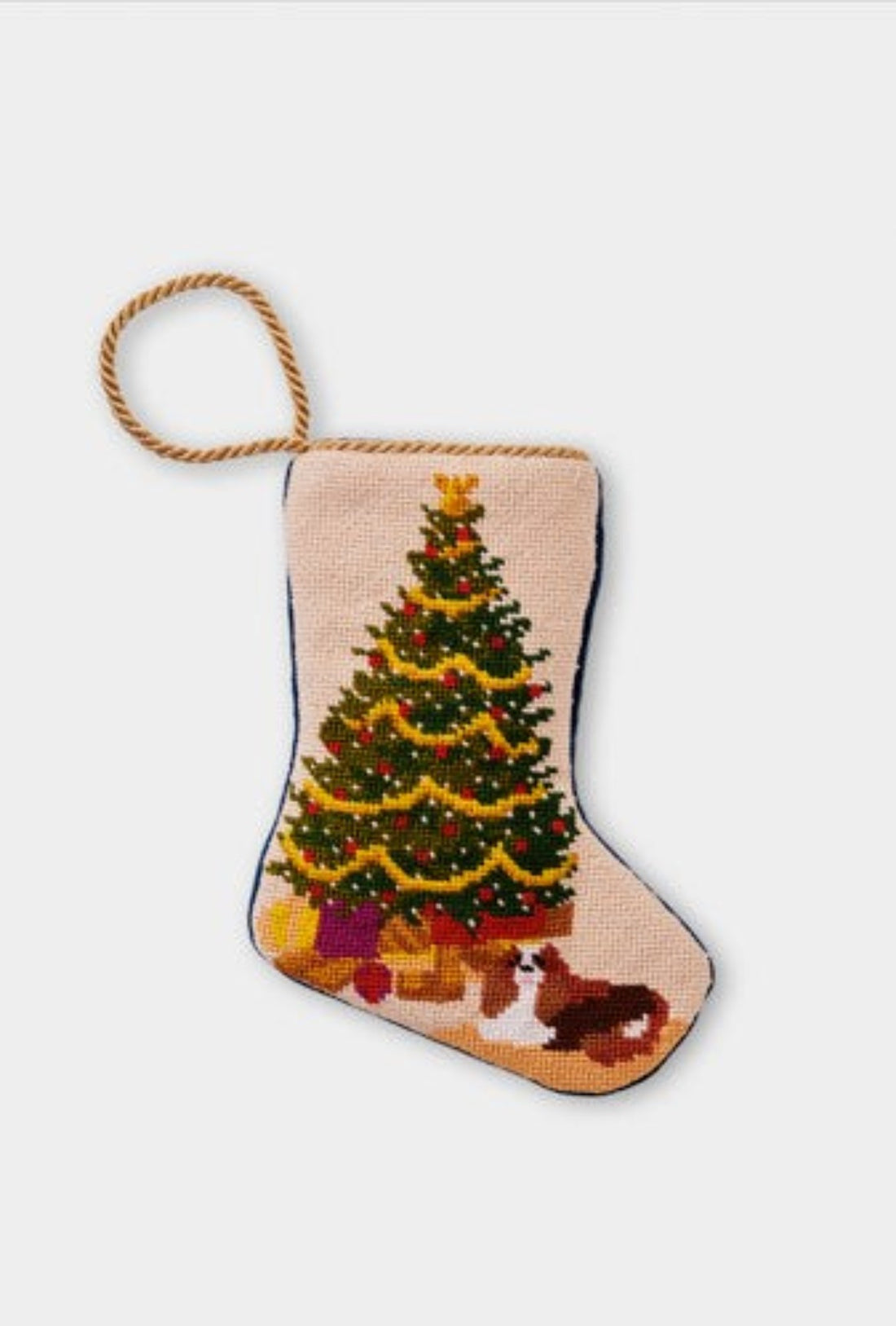Needlepoint Bauble Stockings featuring a decorated Christmas tree with festive gifts and a dog sitting at the tree