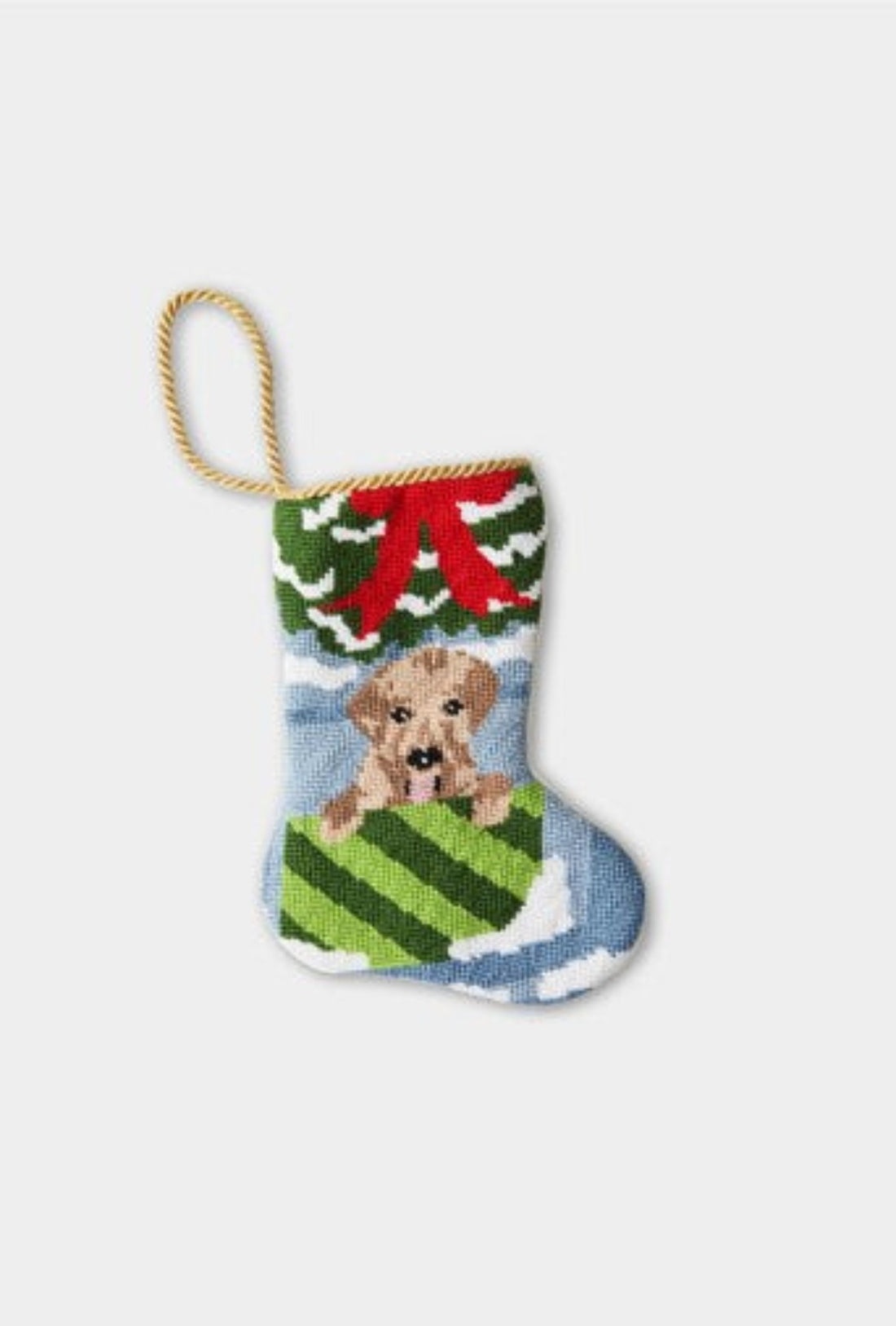 Hand-stitched stocking featuring a puppy in a green-striped box with snow-covered trees and a red holiday bow
