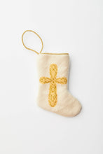 Needlepoint stocking with golden cross on ivory background